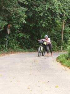 Joanna full force pushing the hill bikepacking Thailand